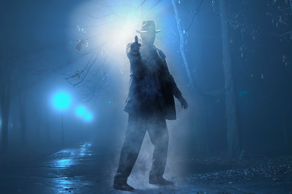 Image of a detective on the street at night aiming his gun